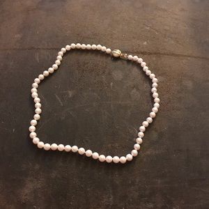 65 Cultured Pearls, hand knotted, 14K Gold clasp.